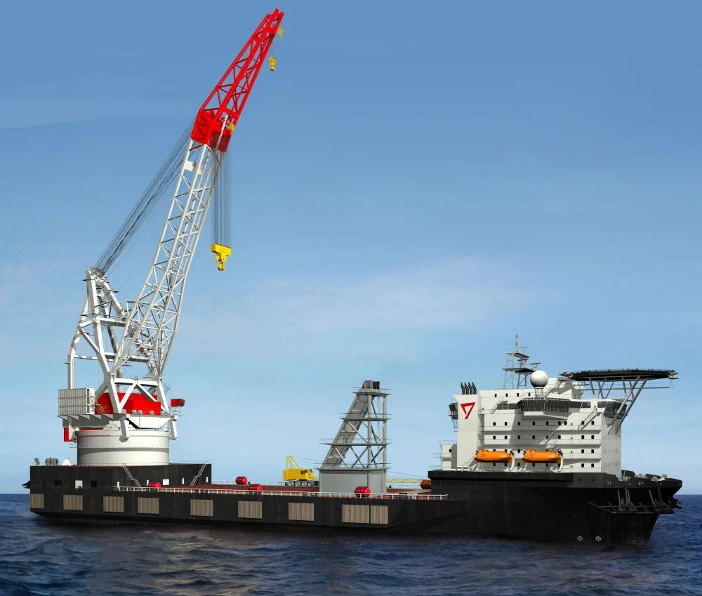 Heavy-lift offshore construction vessel with a red and white deck crane at sea